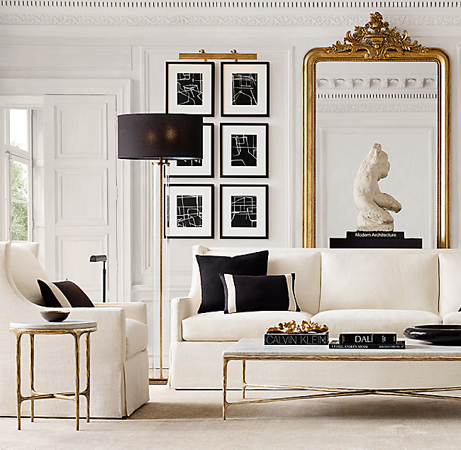 Restoration Hardware living room w/ white sofa and oversized gold mirror