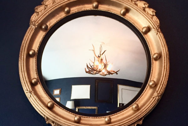 Davis Navy wall color with federal convex gold mirror, chandelier in reflection as well as interior decor